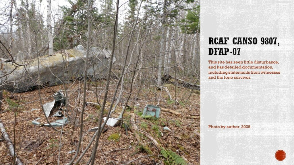 Photo of a large potion of aircraft fuselage in a fall woods. Other parts of the aircraft are scattered through the fall leaf litter. 

Text: RCAF Canso 9807, DfAp-07. This site has seen little disturbance, and has detailed documentation, including statements from witnesses and the lone survivor.

Caption: Photo by author, 2009.