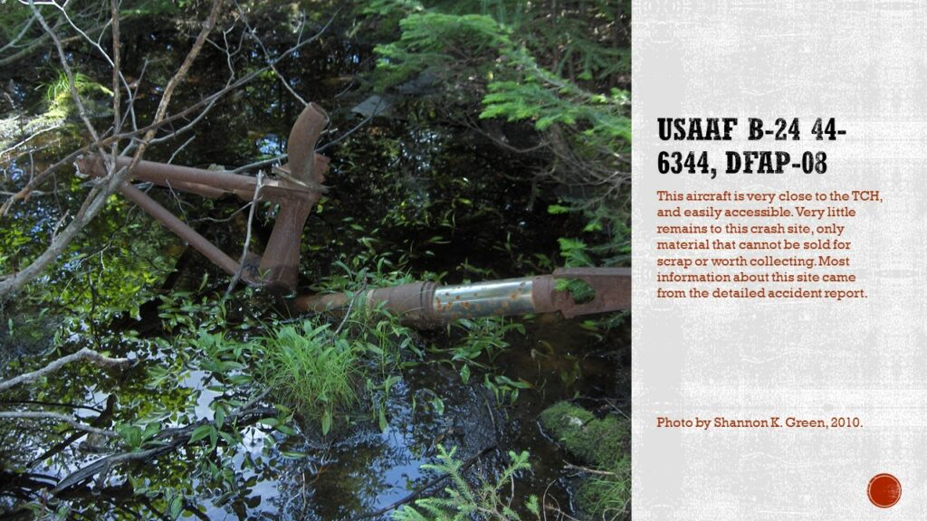 Photo of a landing gear in a swampy looking pond. The steel is rusted, and trees surround the piece.

Text: USAAF B-24 44-6344, DfAp-08. This aircraft is very close to the TCH, and easily accessible. Very little remains to the crash site, only material that cannot be sold for scrap or worth collecting. Most information about this site came from the detailed accident report.

Caption: Photo by Shannon K. Green, 2010.